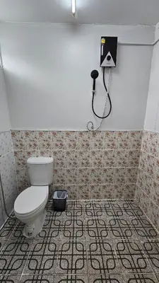 a bathroom with a toilet and a camera on the wall at Cozy 1-Bedroom Bungalow with Shared Pool in Rawai in Nai Harn Beach
