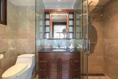 a bathroom with a toilet and a sink and a shower at Villa Gecko with sea view pool, walk to Beach & Restaurants in Surin Beach