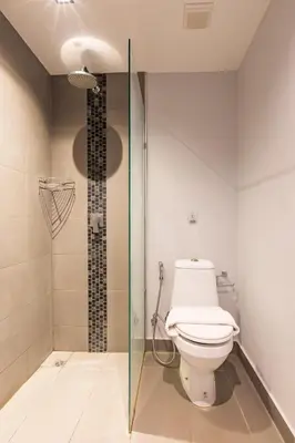 a bathroom with a toilet and a glass shower at Modern Condo - 1BR T1-201 in Ban Klang