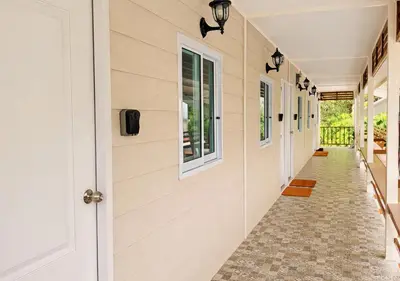 a hallway of a house with a door and windows at MBB House in Thalang