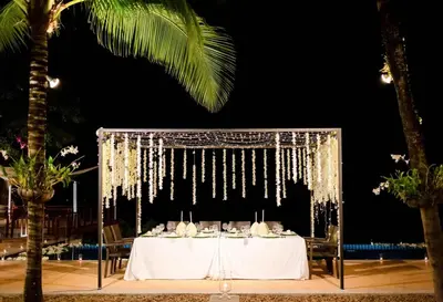 a table set up for a wedding at night at Villa Talaefun - Luxury Oceanfront Fully Serviced in Kamala Beach