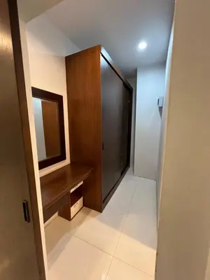 a hallway with a wooden cabinet and a mirror at Nern khao Guesthouse in Kamala Beach