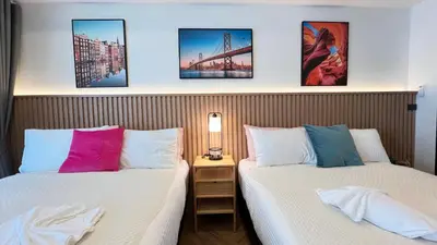 two beds sitting next to each other in a room at Charming home patong in Patong Beach