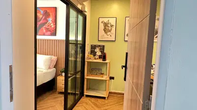 a room with a bedroom with a bed and a mirror at Charming home patong in Patong Beach