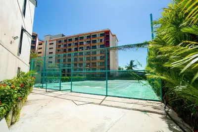 a tennis court in front of a building at Cosy studio near the best beach on Phuket in Ban Mai Salae