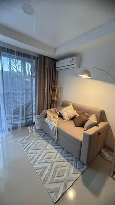 a living room with a couch in a room at Kates cozy place in Mai Khao Beach