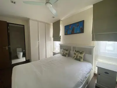 a bedroom with a white bed with pillows on it at 4bdr Villa with gym and pool in Laguna #168 in Laguna Phuket