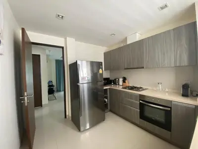 a kitchen with a stainless steel refrigerator and cabinets at 4bdr Villa with gym and pool in Laguna #168 in Laguna Phuket