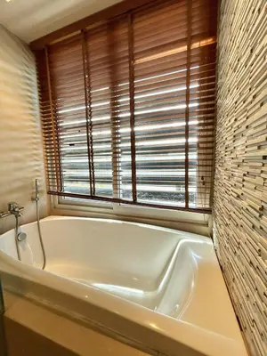 a white bath tub in a bathroom with a window at 1 bedroom Suite Seaview In Kalim in Patong Beach