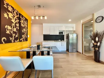 a kitchen and dining room with a table and chairs at 1 bedroom Suite Seaview In Kalim in Patong Beach