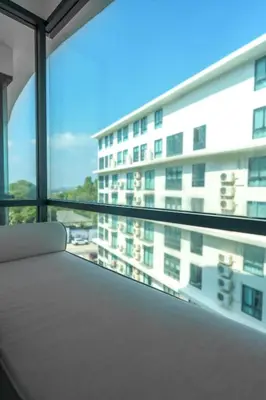 a room with a large window with a building at View 2Bdr Lux Life Rawai in Rawai Beach
