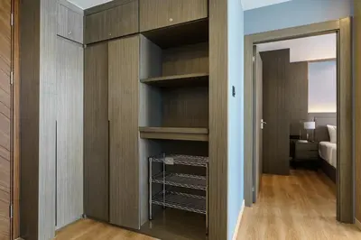 a walk in closet with wooden cabinets and a bedroom at View 2Bdr Lux Life Rawai in Rawai Beach