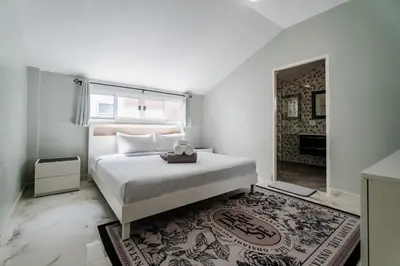 a bedroom with a large white bed and a window at Flora 2 Bedroom HouseNear Naiharn - Rawai Beach in Rawai Beach