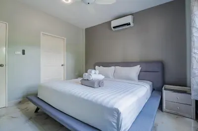 a bedroom with a white bed with two stuffed animals on it at Flora 2 Bedroom HouseNear Naiharn - Rawai Beach in Rawai Beach