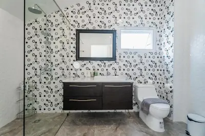 a bathroom with a toilet and a sink and a mirror at Flora 2 Bedroom HouseNear Naiharn - Rawai Beach in Rawai Beach