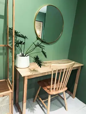 a mirror on a table with a chair and a plant at Midori Rawai Hotel in Ban Saiyuan (1)