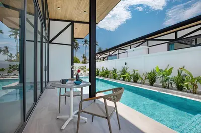 an outdoor patio with a table and chairs next to a swimming pool at 3BR Villa Sunset Garden 12 - Private 18m Pool in Rawai in Rawai Beach