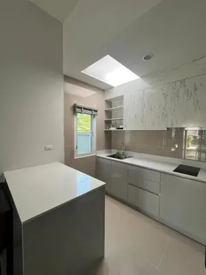 a large white kitchen with a white counter top at The Rich Villas Palai in Chalong