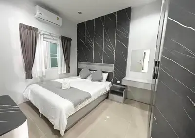 a bedroom with a white bed and a window at The Rich Villas Palai in Chalong