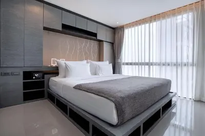 a bedroom with a large bed and a window at Green View Suite CTG P210 at Tropics Kamala Residence near Fantasea in Kamala Beach