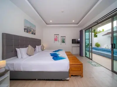 a bedroom with a large bed and a pool at 2Exclusive 4BR Villa with Private Pool Kitchen Ideal for Families in Ban Bang La