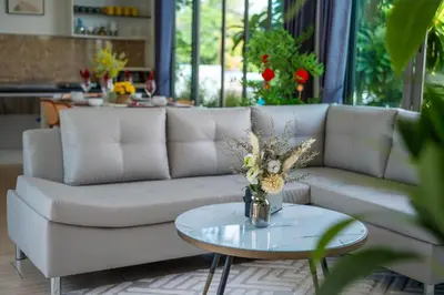 a living room with a white couch and a table at 3Elegant 4BR Villa with Pool in Ban Bang La