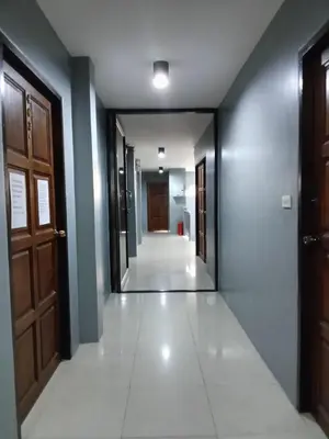 a hallway with doors and a tile floor at Sparta beachfront patong in Patong Beach