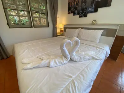a bed with two swans made out of towels at Prime Hill Kathu Phuket D3 in Ban Ket Ho