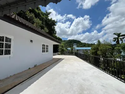 a walkway leading to a white building at Prime Hill Kathu Phuket D3 in Ban Ket Ho