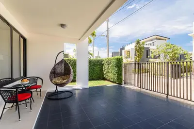 a patio with a table and chairs on a balcony at Laguna Park Townhouse by Villacarte in Laguna Phuket
