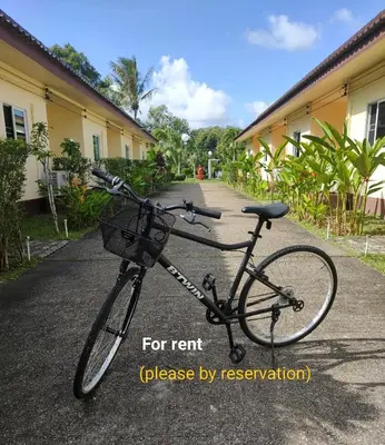 a bike parked in front of a building at Orchidilla Residence Phuket Mai Khao Beach - SHAPlus in Mai Khao Beach