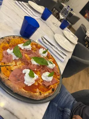 a pizza sitting on top of a table at The little Mermaid in Patong Beach
