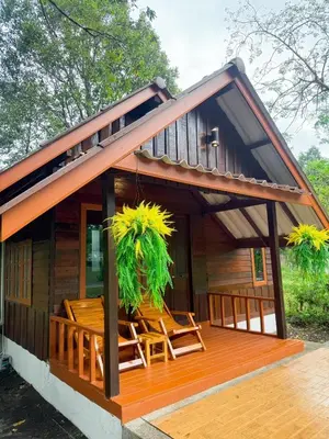 a cabin with a deck with chairs on it at Green Haven Villas in Krabi town