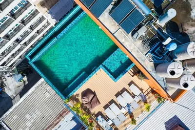 an overhead view of a swimming pool next to a building at Phuket Patong Buri Resort in Patong Beach