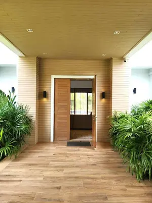 a front door of a house with plants at WEG Laguna Residence in Thalang