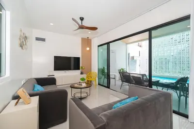 a living room with two couches and a tv at 6BR Patong pool villa in Patong Beach