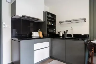 a kitchen with black and white counter tops at Patong luxurious Vacation one bedroom Apt The deck in Patong Beach