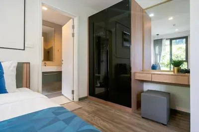 a bedroom with a bed and a bathroom with a mirror at Patong luxurious Vacation one bedroom Apt The deck in Patong Beach