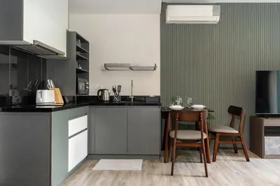 a kitchen with a table and two chairs and a counter at Patong luxurious Vacation one bedroom Apt The deck in Patong Beach