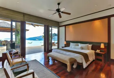 a bedroom with a bed and a television and a couch at Villa Daran Luxury Villa with Panoramic Views & 5-Star Services in Kamala Beach