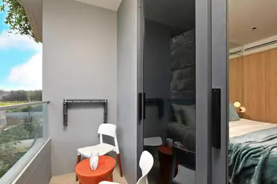 a small bedroom with a bed and a balcony at 1bdr New Apartment near Layan Beach in Ko Kala