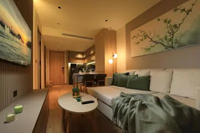 a living room with a couch and a table at 1bdr New Apartment near Layan Beach in Ko Kala