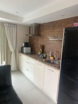 a kitchen with a sink and a microwave at Cristians lägenhet in Kata Beach
