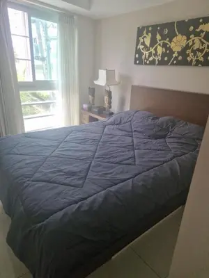 a bedroom with a blue bed with a window at Cristians lägenhet in Kata Beach