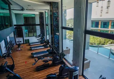 a gym with rows of treadmills and exercise bikes at Surin Mida Grande residence with jacuzzi and sea view - Bang Tao & Surin beach in Surin Beach