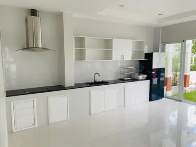 a kitchen with white cabinets and a sink at Supicha86 Sino ko kaeo Modern Private 3BR 3BA Villa in Ban Bang Khu