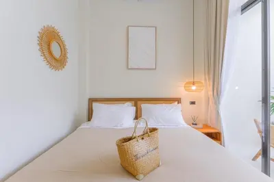 a bedroom with a bed with a basket on it at Balina Private Pool Villa in Ban Chin Tham Mai