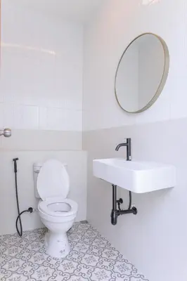 a white bathroom with a toilet and a sink at Balina Private Pool Villa in Ban Chin Tham Mai