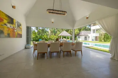a dining room with a table and chairs and a pool at Top Pool Villa Layan Estate Laguna Bangtao in Layan Beach
