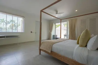 a bedroom with a large bed and a bathroom at Top Pool Villa Layan Estate Laguna Bangtao in Layan Beach